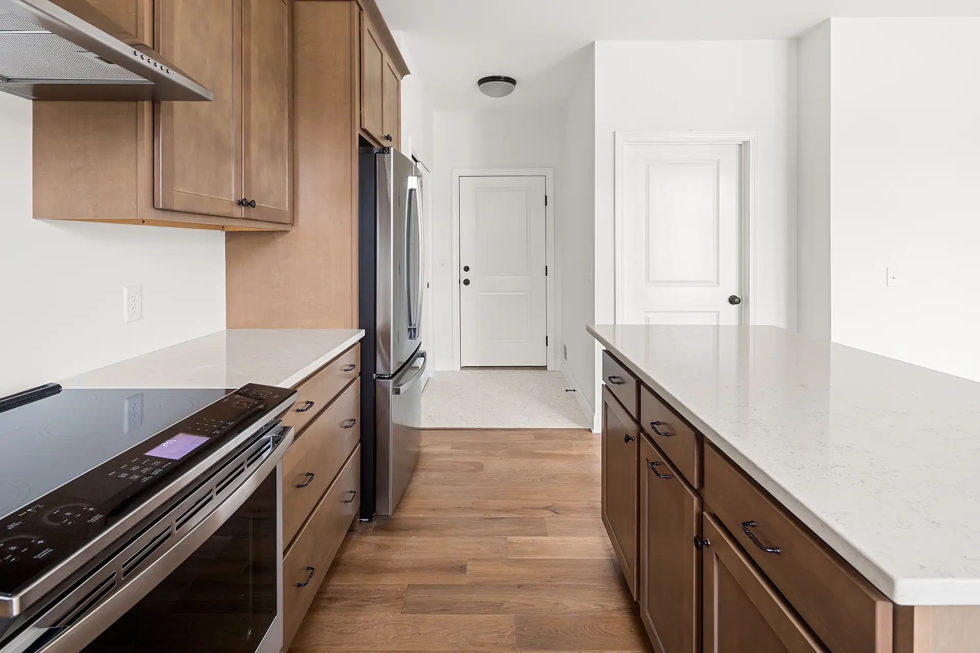 wood kitchen galley view stainless range fridge back door